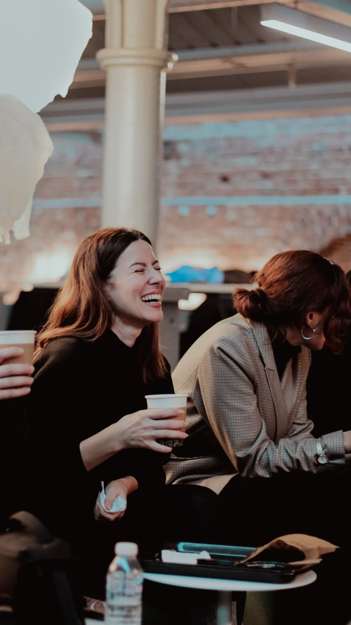 Women gathered around a table, mid-conversation