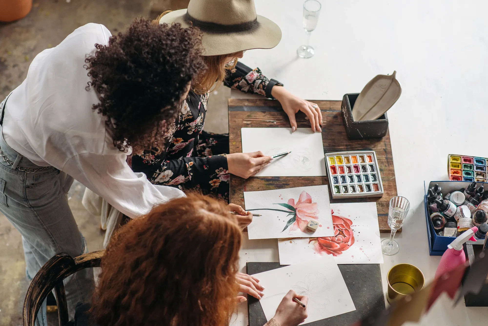 Women working side by side at a crowded worktable