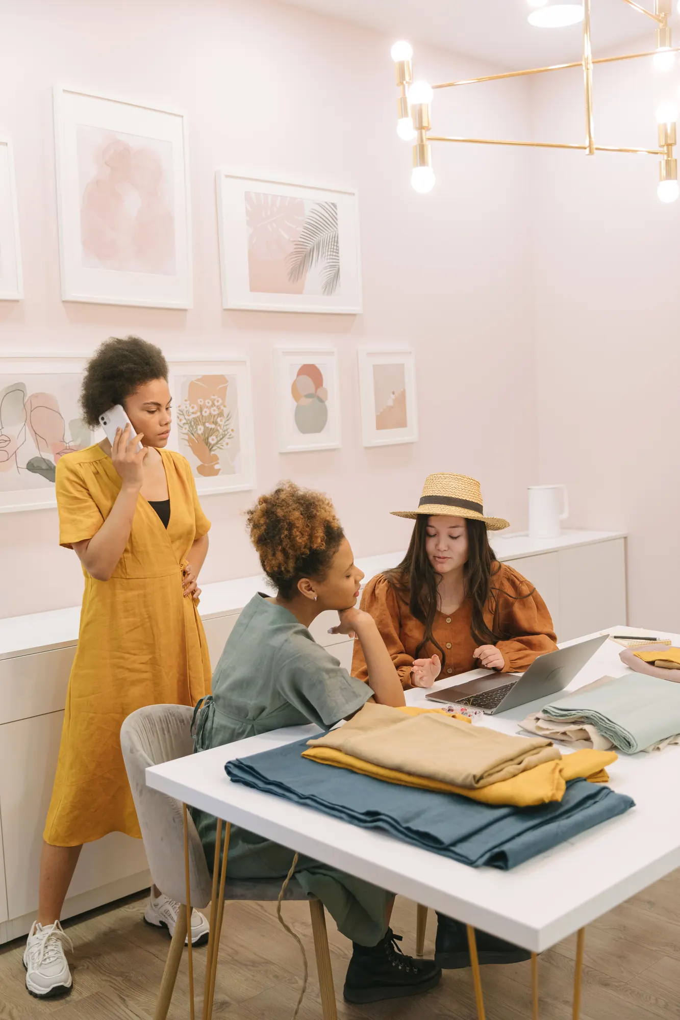 Women talking through a project in a bright studio